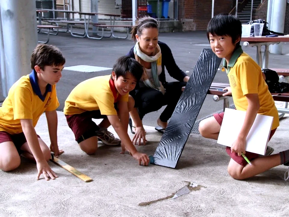 A MyScience facilitator supporting students during an outdoor ramp investigation